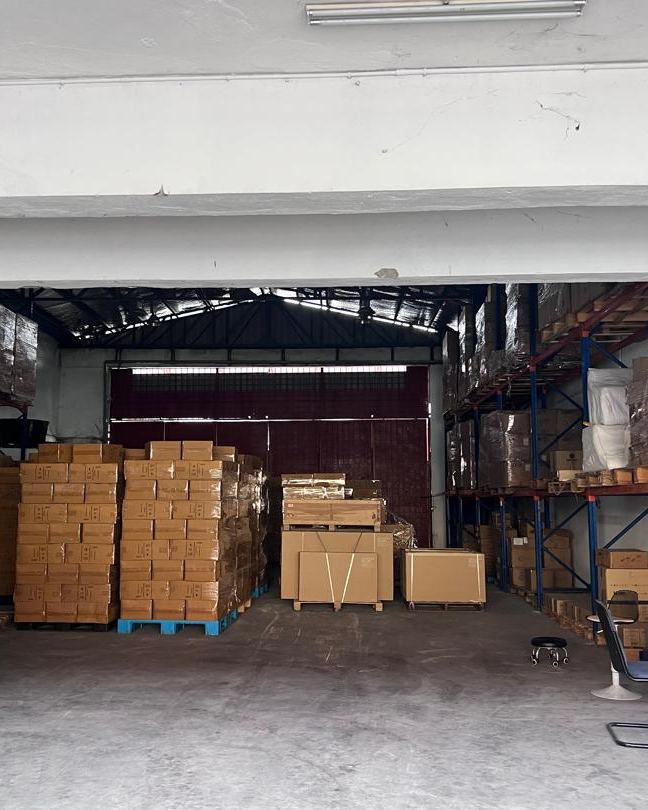 Stacked cartons and racking in the Hock Cheong second staging area