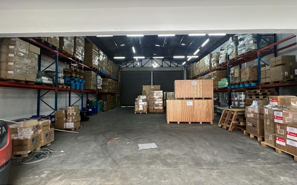 Racked pallets and crated cargo in a Hock Cheong staging area where cargo is received
